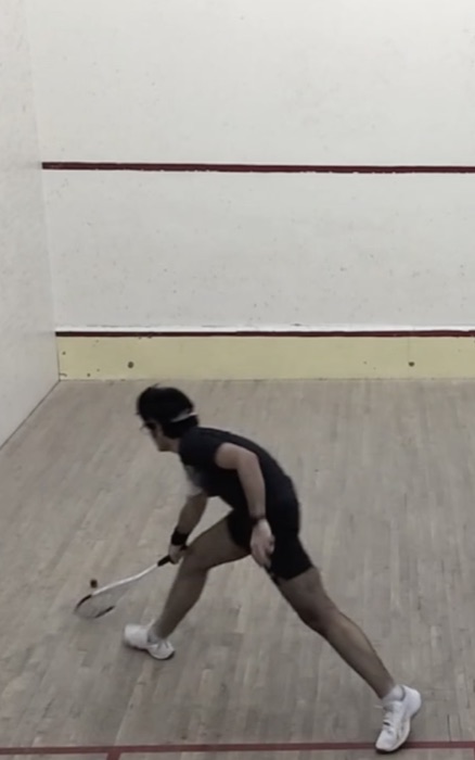 Reaching low for a forehand on court