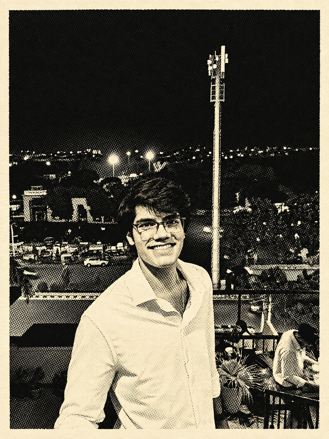 Ishan smiling on a rooftop at night, city lights in the background, in a halftone-print photo style.
